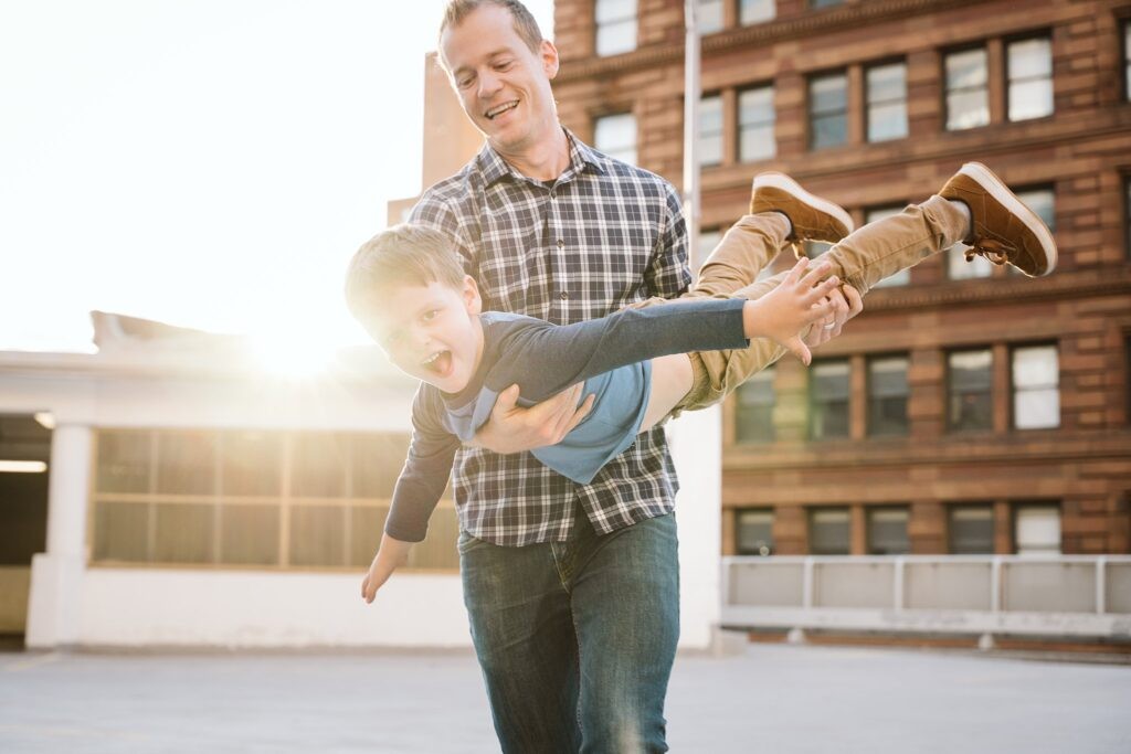 dad holding son during family lifestyle session, downtown Pittsburgh