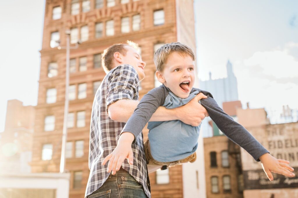 dad holding son during family lifestyle session, downtown Pittsburgh