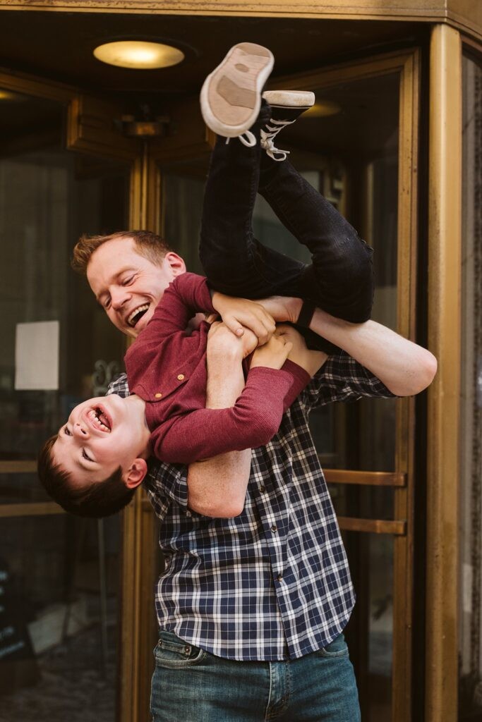 dad holding son during family lifestyle session, downtown Pittsburgh