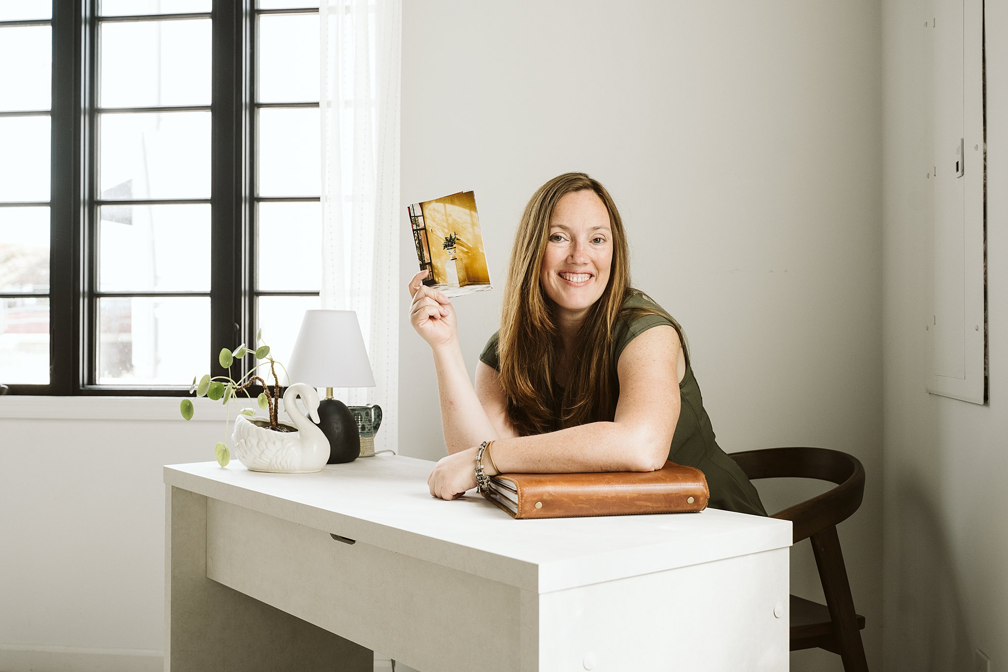 Laura Mares photographer holding photograph in studio near Pittsburgh, PA