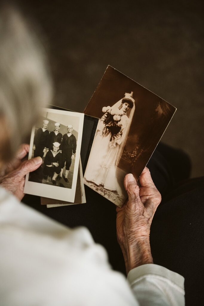 editorial photograph of senior woman at home with family photos