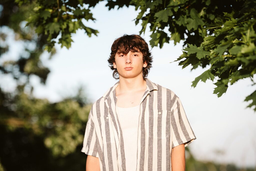 senior guy portraits at golden hour in rural setting