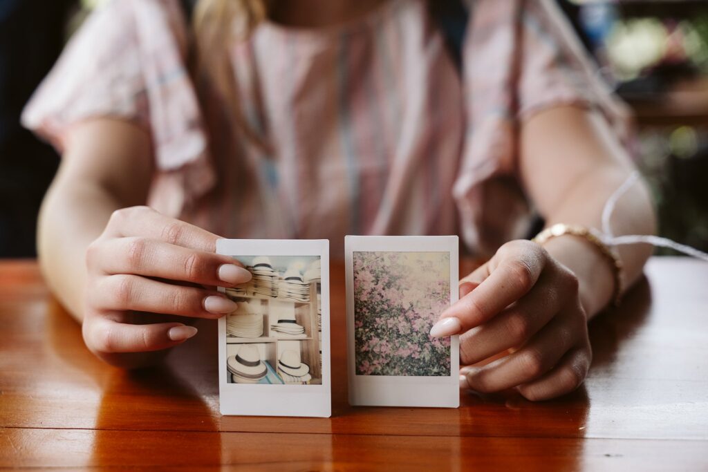 hands holding polaroids of colombia