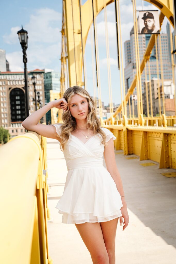 senior photo of girl standing on Roberto Clemente bridge