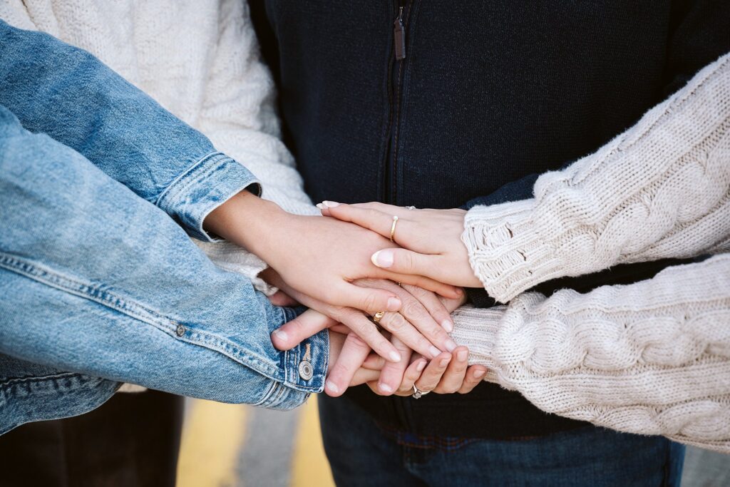 Family members gathering their hands together during a family portrait session in Pittsburgh