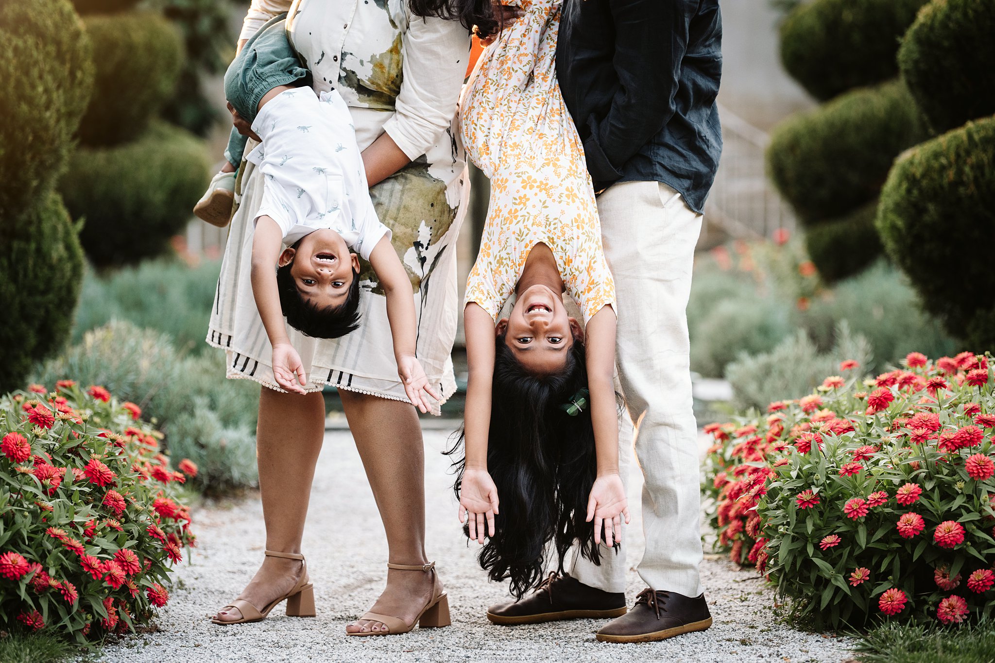 fun family portrait of parents holding kids upside down