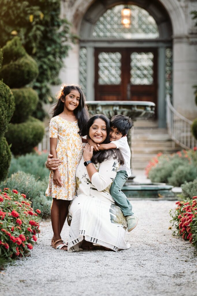 mother hugging kids in park
