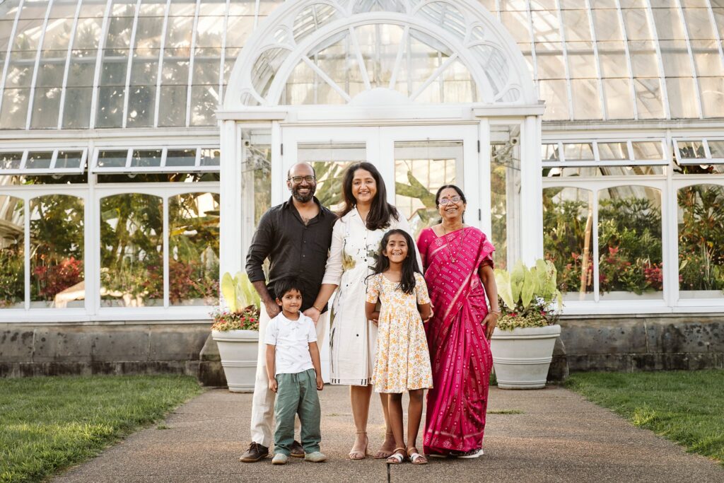 family portrait outside a greenhouse