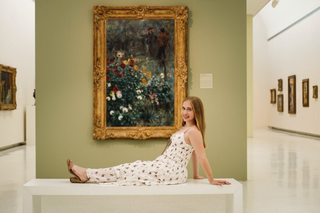 senior girl sitting in front of artwork at Carnegie Museum of Art