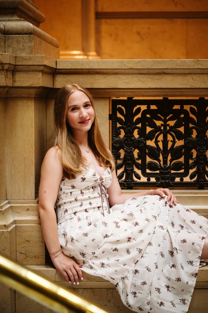 Senior girl sitting on marble at Carnegie Museum